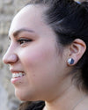 Close-up of black and white geometric hexagon stud earrings made from clay and resin – Fair Anita