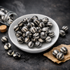 White bowl filled with black and white striped beans on a dark surface