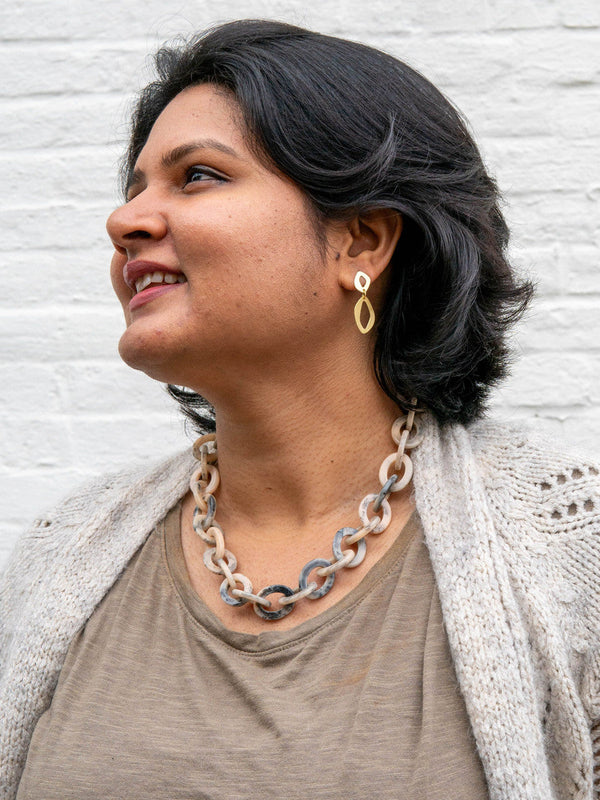 Close-up of blue and cream chunky resin chain link necklace by Fair Anita showing marbled detail