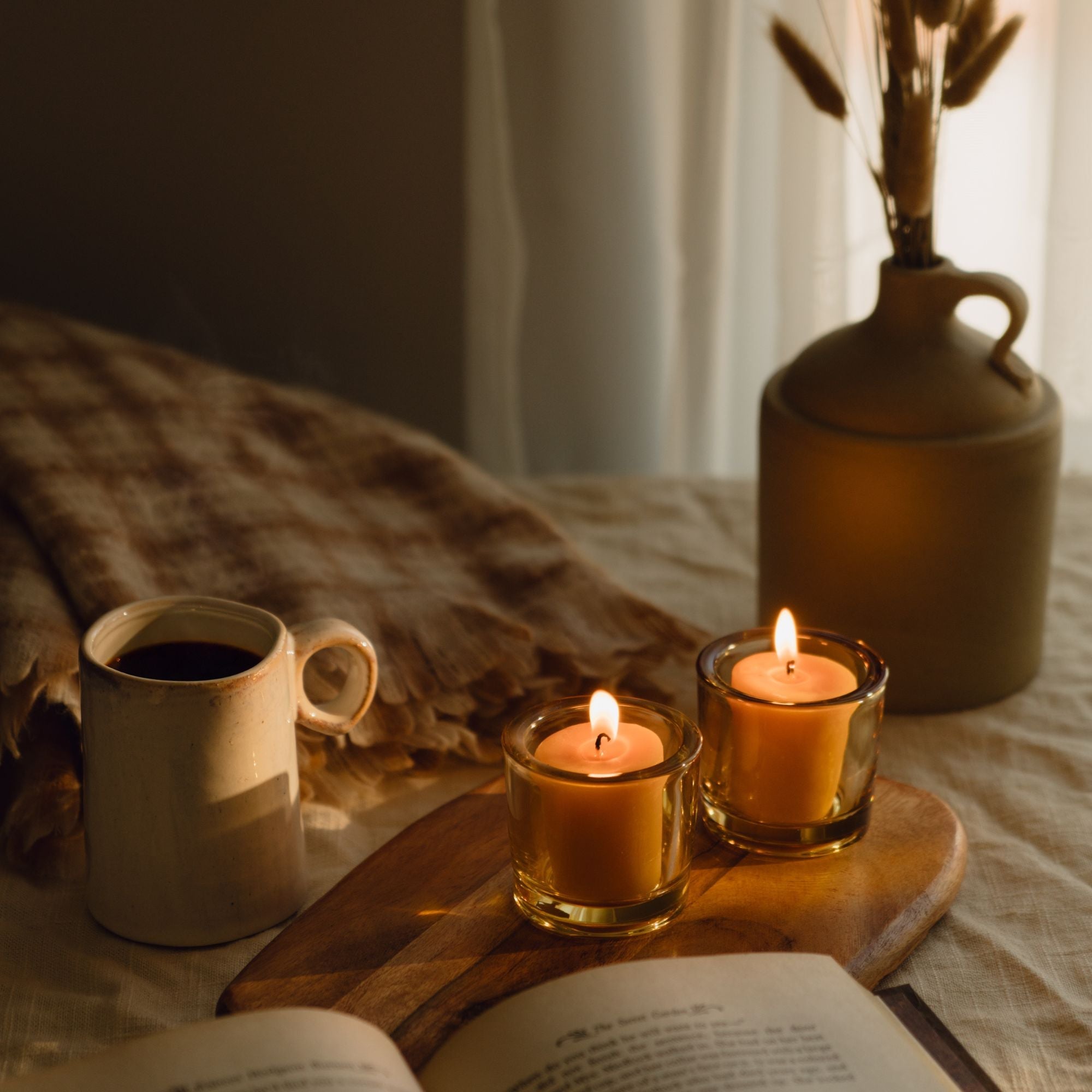Bluecorn beeswax votive candles styled as fall home decor in a cosy setting