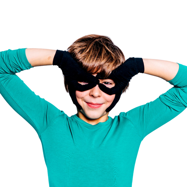 Boy wearing black Remedywear eczema gloves for kids showing snug second-skin fit on hands and wrists