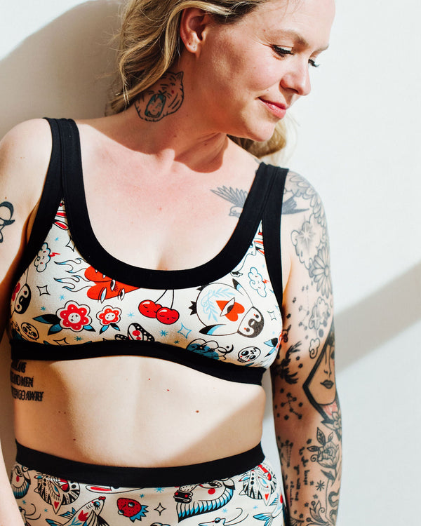 Side view of the Thunderpants Inked Up Bralette showing tattoo-inspired character print detail