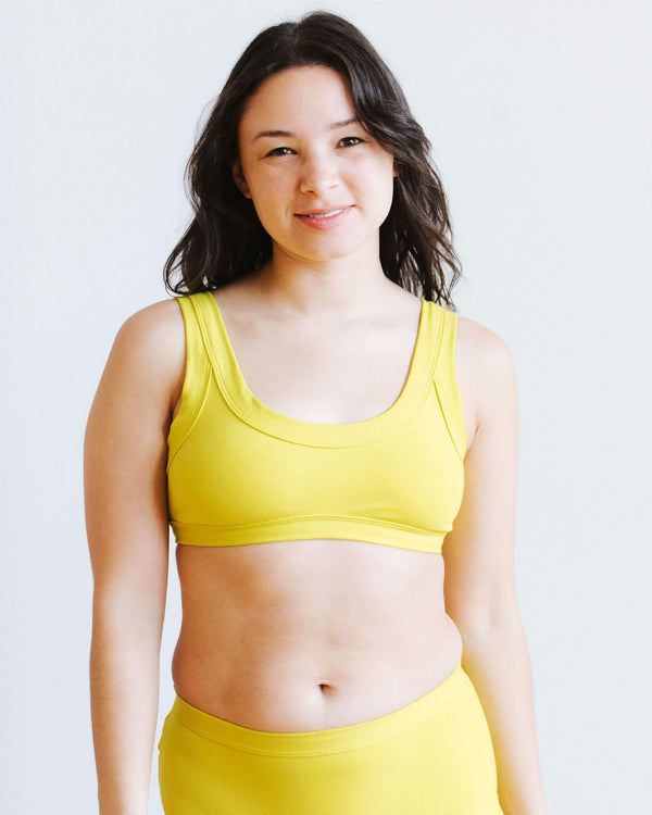 Model wearing Thunderpants Star Fruit Bralette in size medium, front view