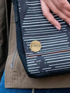 Close-up of brass feminist pin, nickel-free and ethically made, measuring 1 inch – Fair Anita