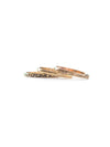 Recycled brass stacking rings in multiple textures displayed together on a neutral background