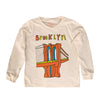 Long-sleeve shirt with a graphic of the Brooklyn Bridge and 'Brooklyn' text on a beige background