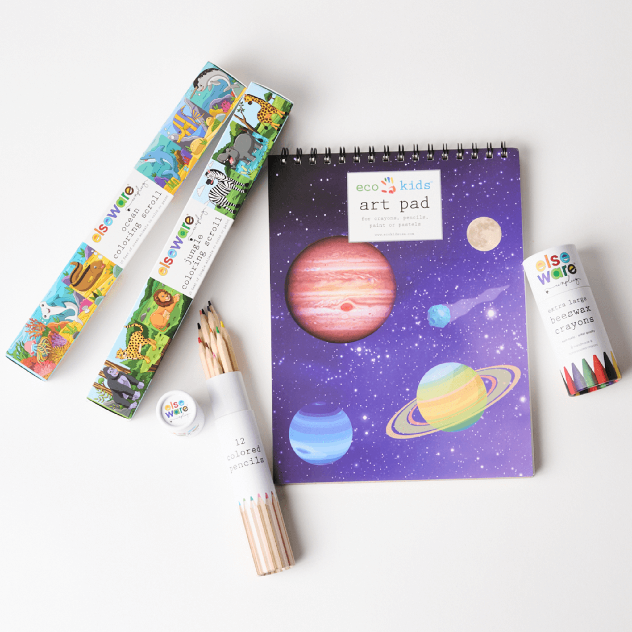 Children's art supplies including a notebook with space-themed design, colored pencils, and markers on a white background.