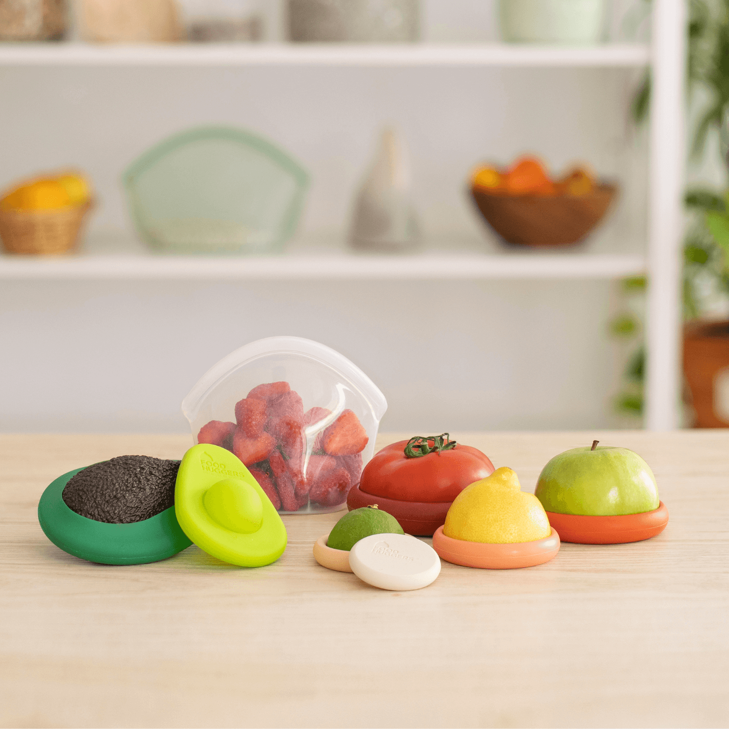 Set of colorful toy fruits and vegetables on a wooden surface with a kitchen background.