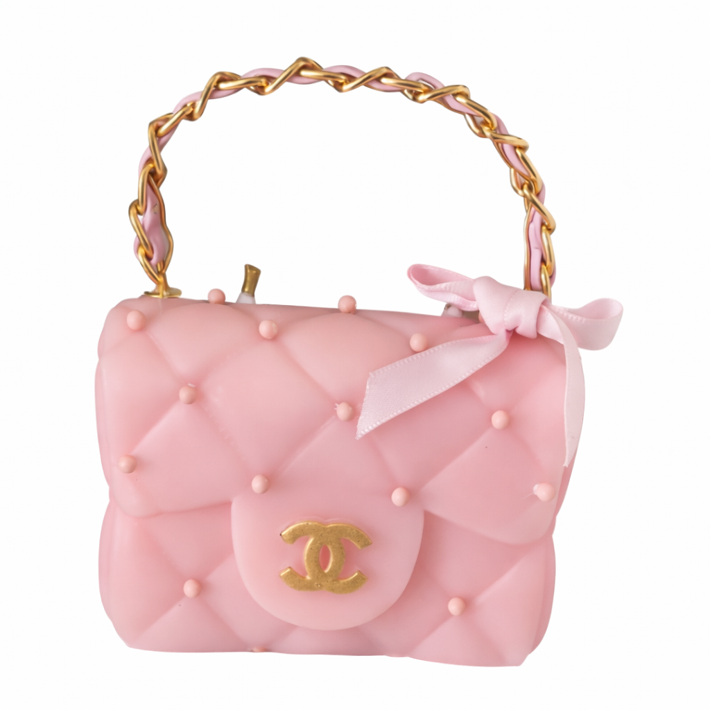 Pink handbag with gold handle and bow on a white background