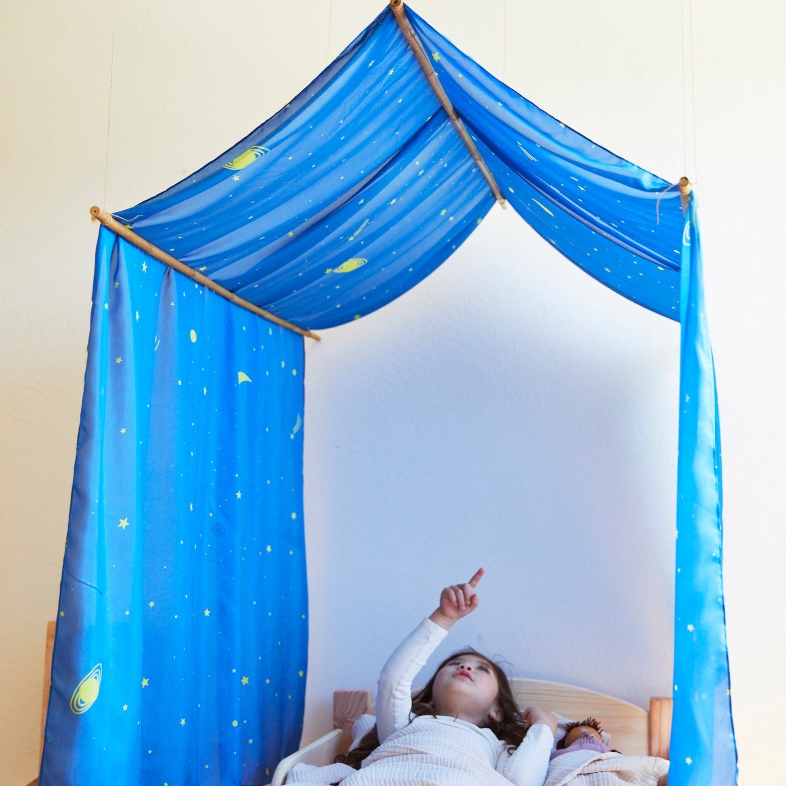 Sarah's Silks Double Star Playsilk draped as a children's bed canopy in a cosy playroom