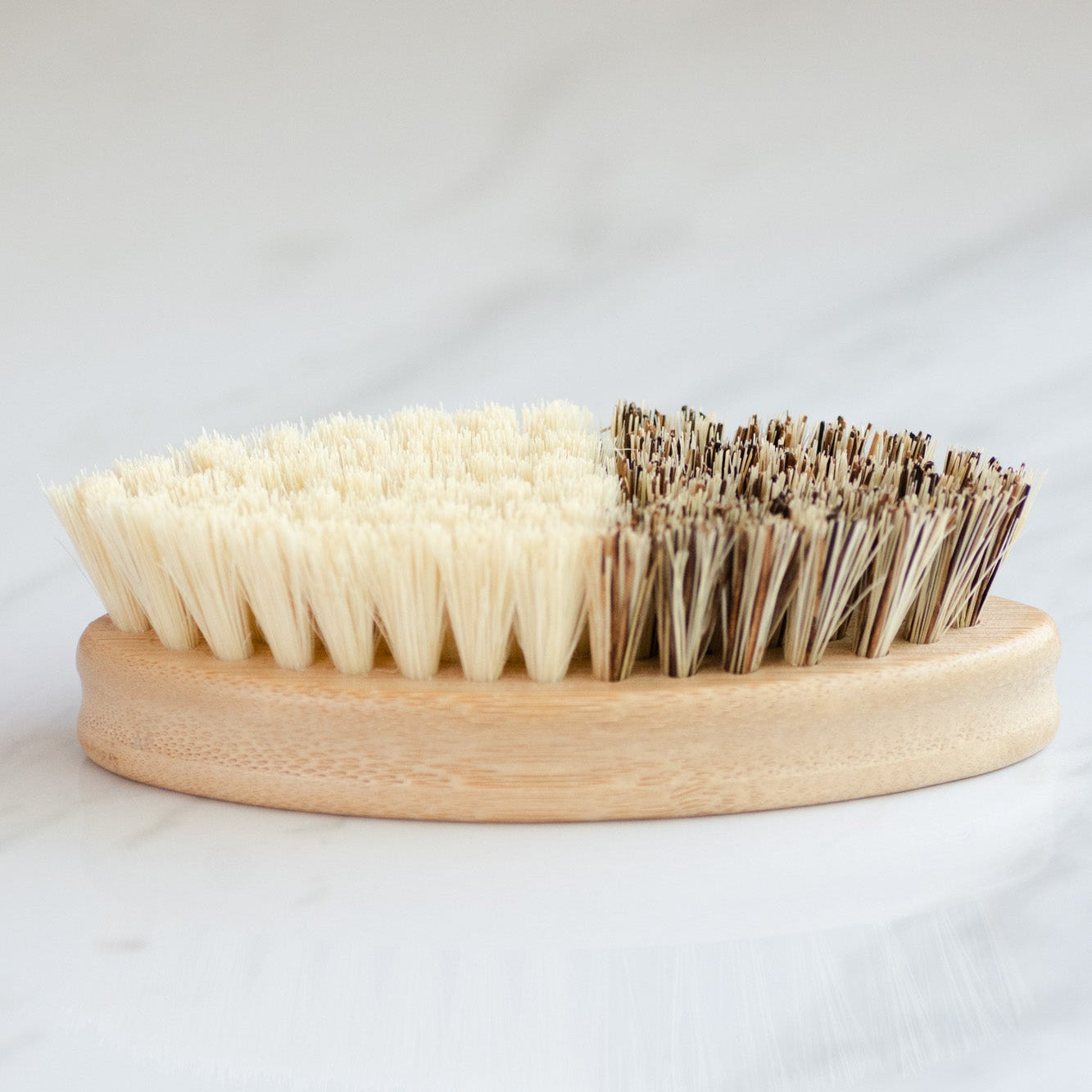 No Tox Life CASA AGAVE® bamboo vegetable brush in use scrubbing fresh produce at the kitchen sink