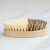 No Tox Life CASA AGAVE® bamboo vegetable brush in use scrubbing fresh produce at the kitchen sink