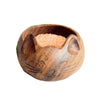 Wooden cat-shaped bowl with sand on a textured surface