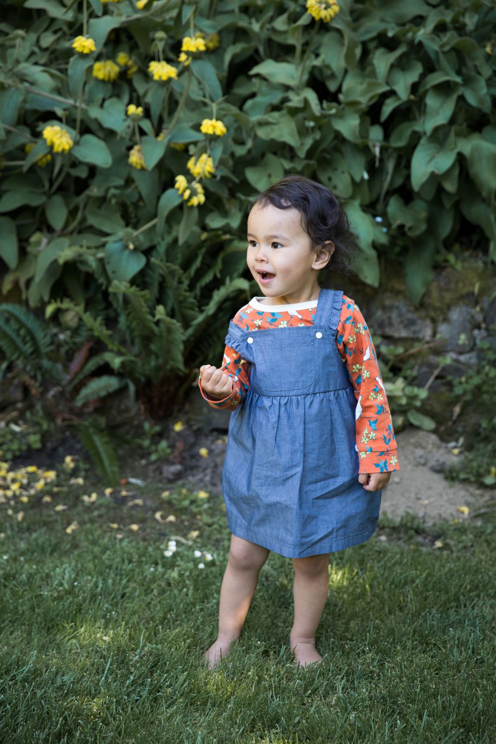 Apple Park organic chambray overall dress styled with long-sleeve shirt underneath, shown in multiple sizes