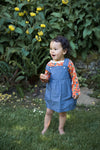 Apple Park organic chambray overall dress styled with long-sleeve shirt underneath, shown in multiple sizes