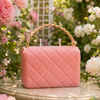 Close-up of The Rose Petite Couture luxury candle — soft pink camellia notes