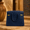 The Bleue Iconic blue handbag candle displayed as a decorative home accent piece by Onali Pure
