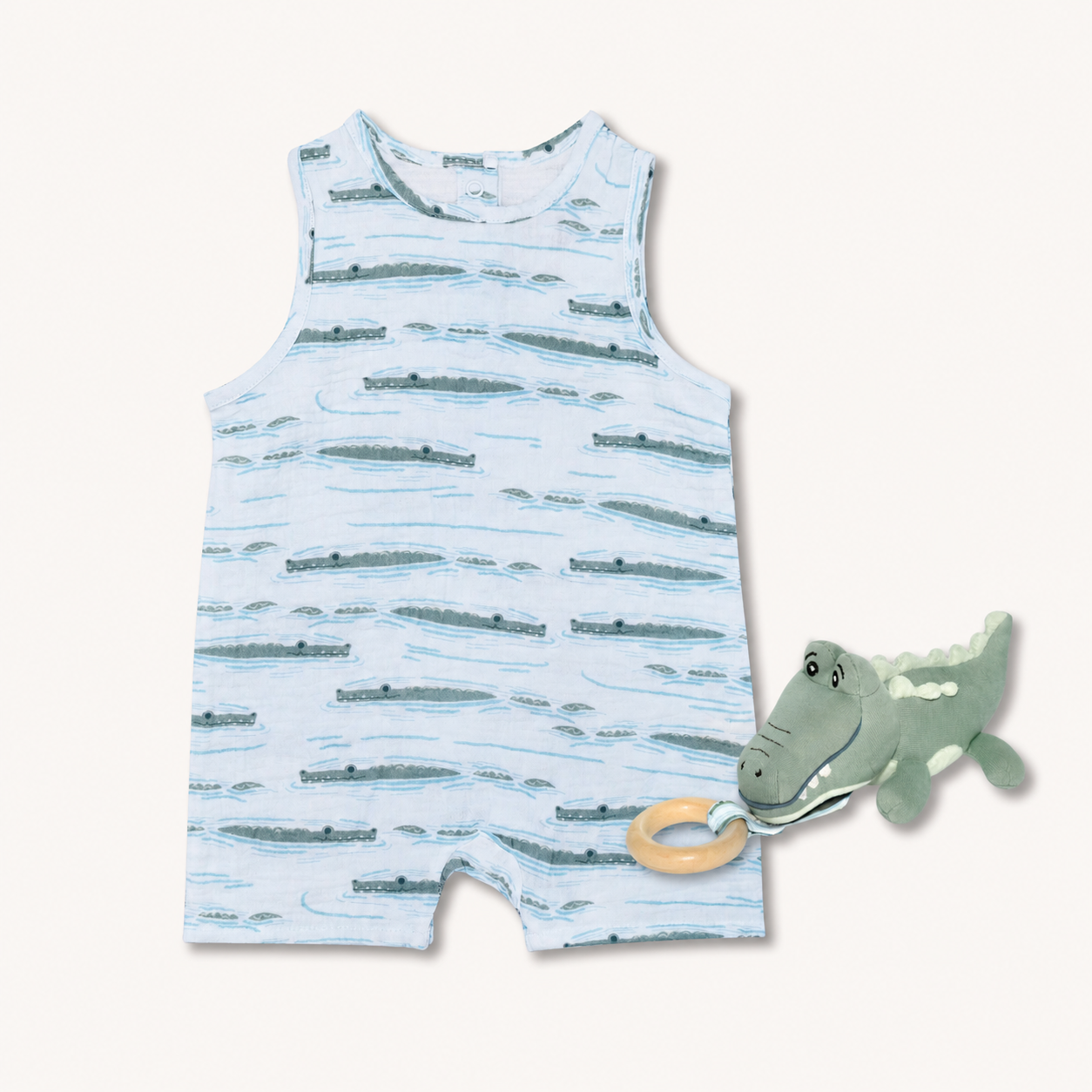Apple Park Alligator Isle organic muslin baby coverall and matching alligator rubberwood teething toy bundle on a soft background