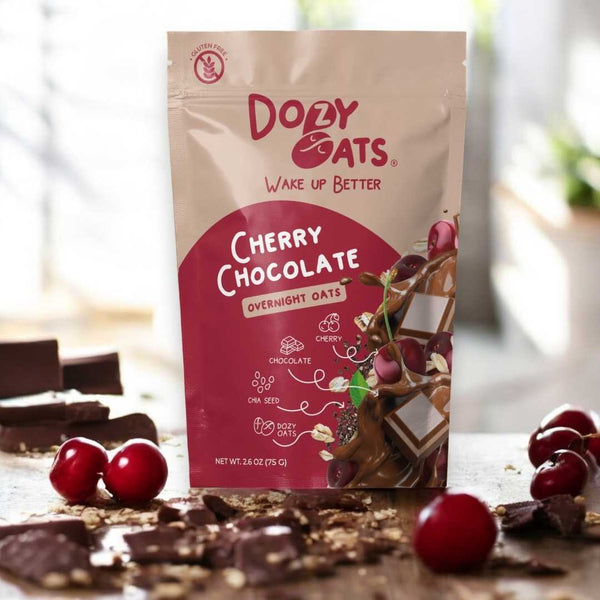 Doley Oats Cherry Chocolate Overnight Oats package with cherries and chocolate on a wooden surface.