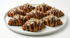 Close-up of hand-rolled sugar-free chocolate croissant with toasted almonds from Andy Anand SoCal Bakery