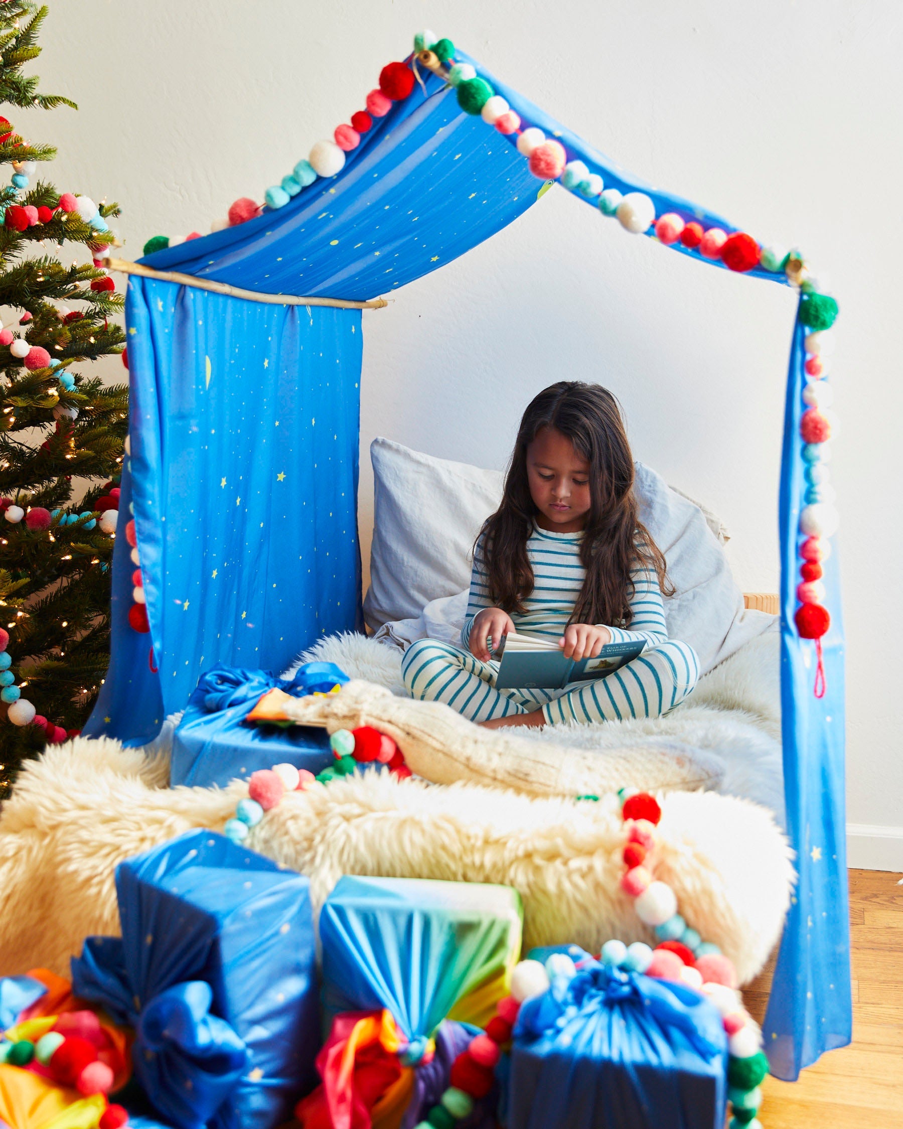 Sarah's Silks Double Star Playsilk used as a festive Christmas canopy decoration in a child's room