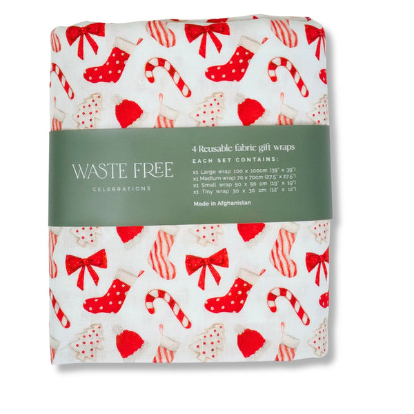 Pack of reusable fabric gift wraps with festive design on a white background