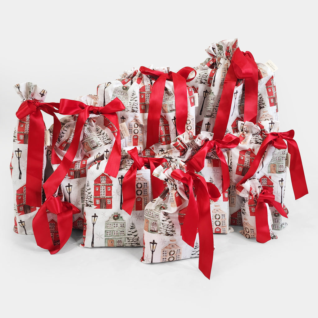 Gift bags with red ribbons on a white background