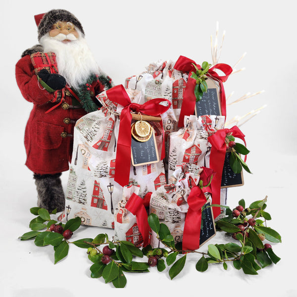 Decorative gift with red ribbons and a Santa figure on a white background
