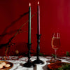 Christmas tablescape featuring cast iron taper holders with Bluecorn beeswax tapers and festive décor
