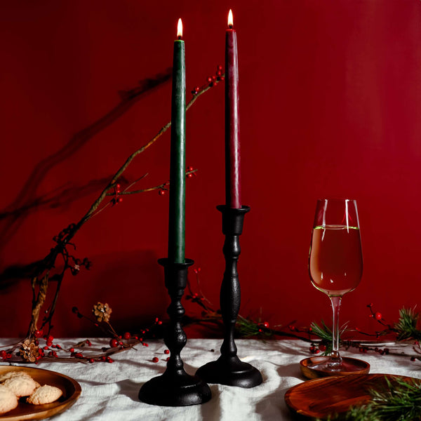 Christmas tablescape featuring cast iron taper holders with Bluecorn beeswax tapers and festive décor
