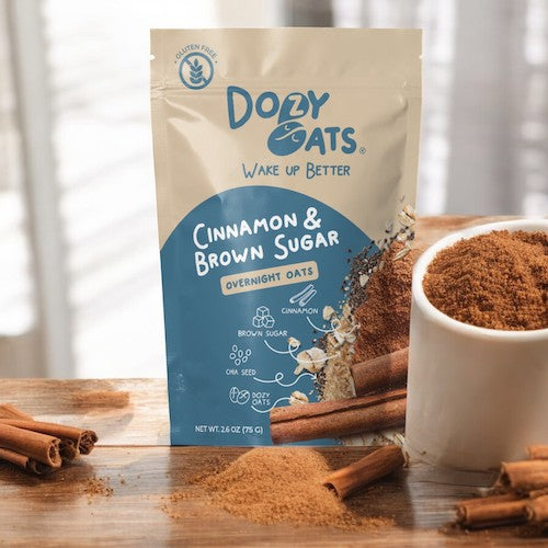 Doley Oats Cinnamon & Brown Sugar Overnight Oats package with cinnamon sticks and a bowl of oats on a wooden surface.