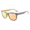 Sunglasses with floral patterned frame and yellow-tinted lenses on a white background
