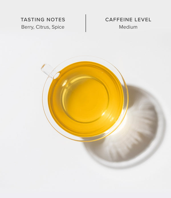 Tea cup with yellow liquid on a white background, featuring tasting notes and caffeine level information.