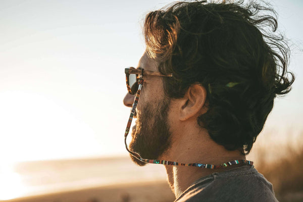 Man with sunglasses on his head looking into the distance with a blurred background