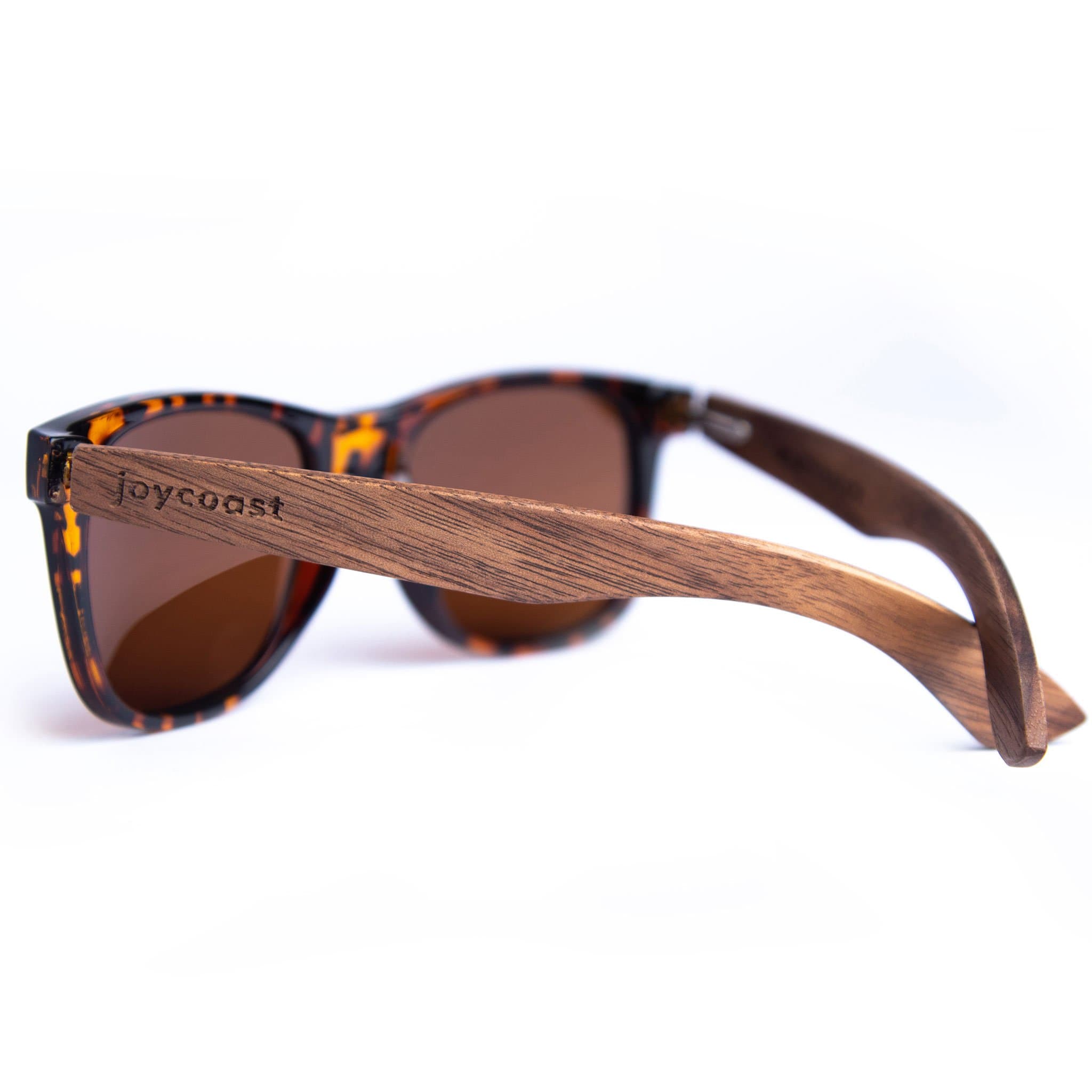Person wearing Joycoast Crush walnut wood sunglasses outdoors in natural light