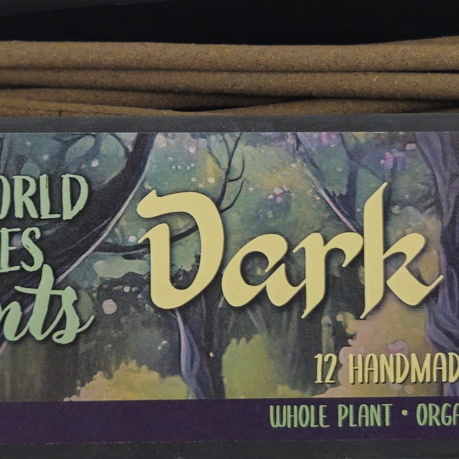 Close-up of Dark Forest handmade incense sticks with botanical ingredients including agarwood and juniper berries