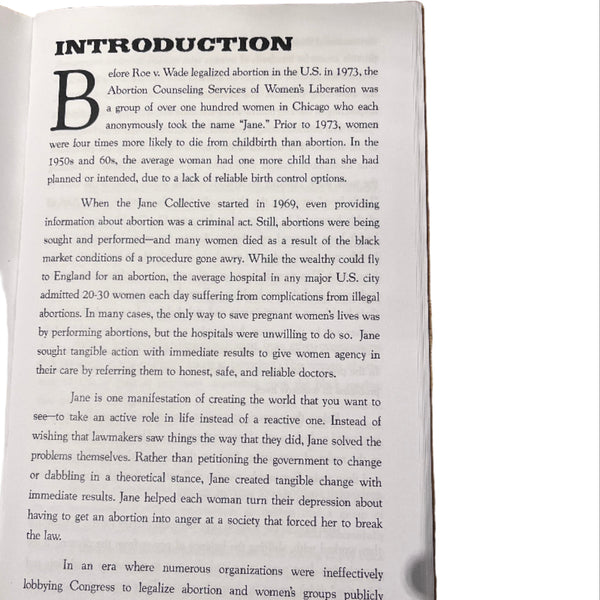 Open book on a wooden surface with visible text
