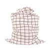 Close-up of EverWrap EverTie bag satin ribbon closure on black grid fabric