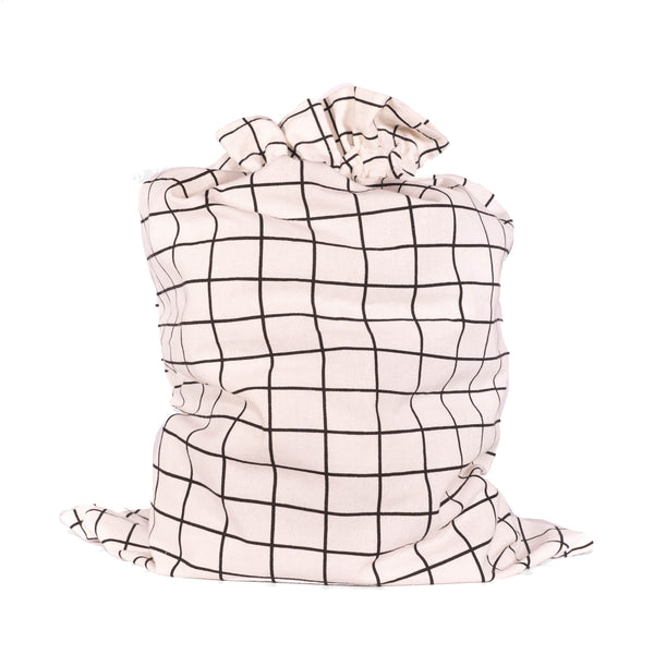 Close-up of EverWrap EverTie bag satin ribbon closure on black grid fabric