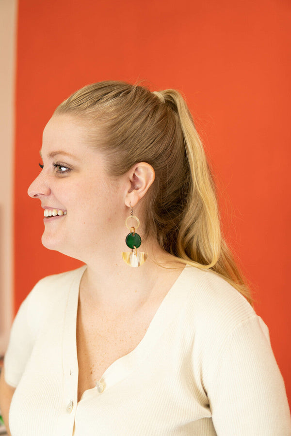 Close-up of lightweight upcycled horn statement earrings in two lengths, nickel-free