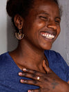 Woman wearing brass-plated palm leaf fan earrings – nickel-free fair trade earrings by Fair Anita