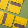 Yellow card holders with gray interior on a green background