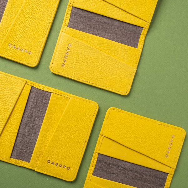 Yellow card holders with gray interior on a green background