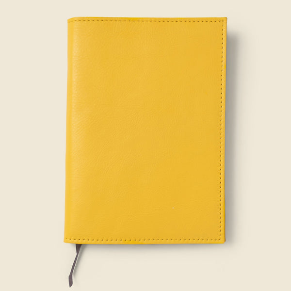 Yellow notebook on a light beige background
