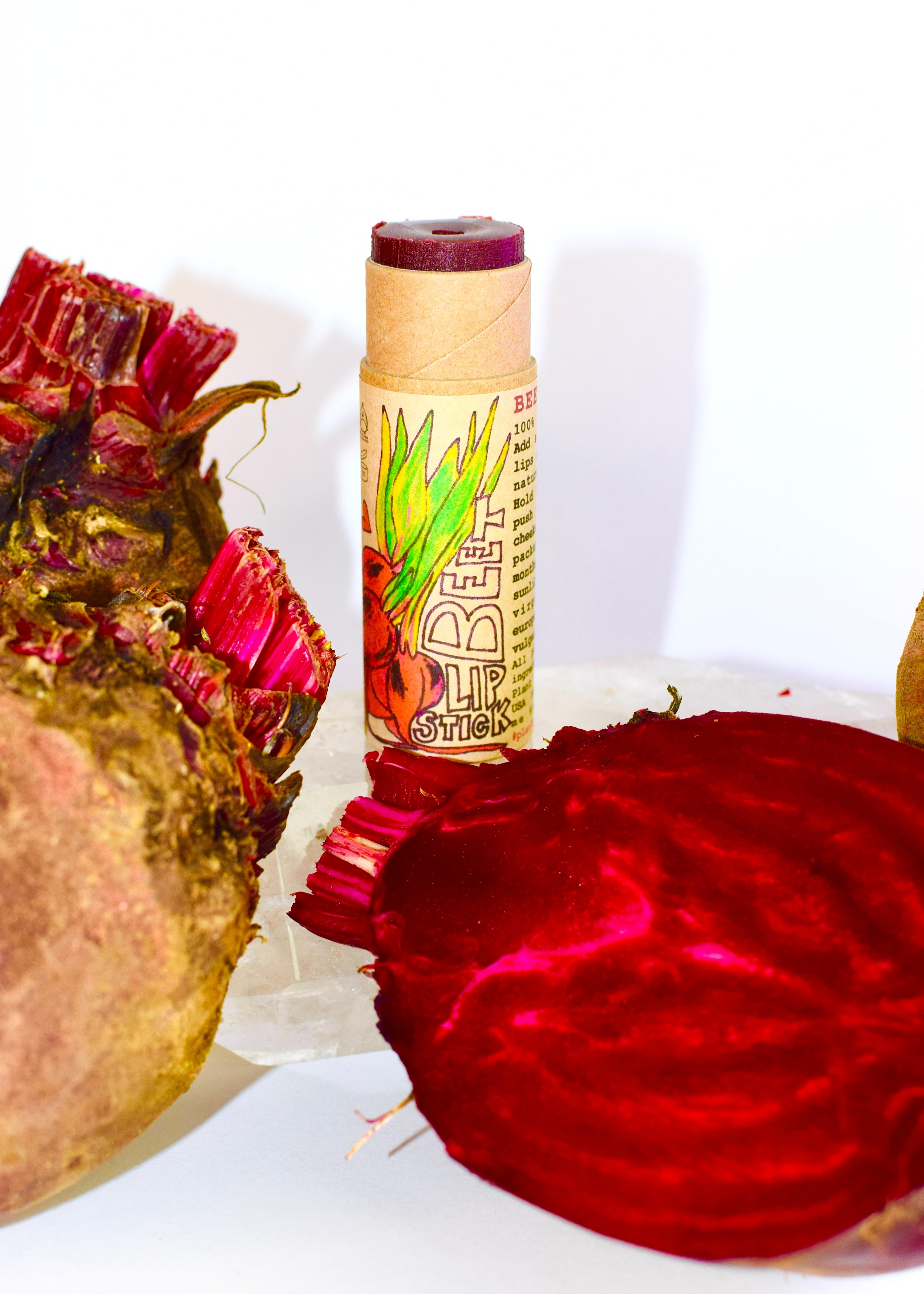 Plant Makeup Beet Lip Stick beside fresh beet roots — organic natural lip balm