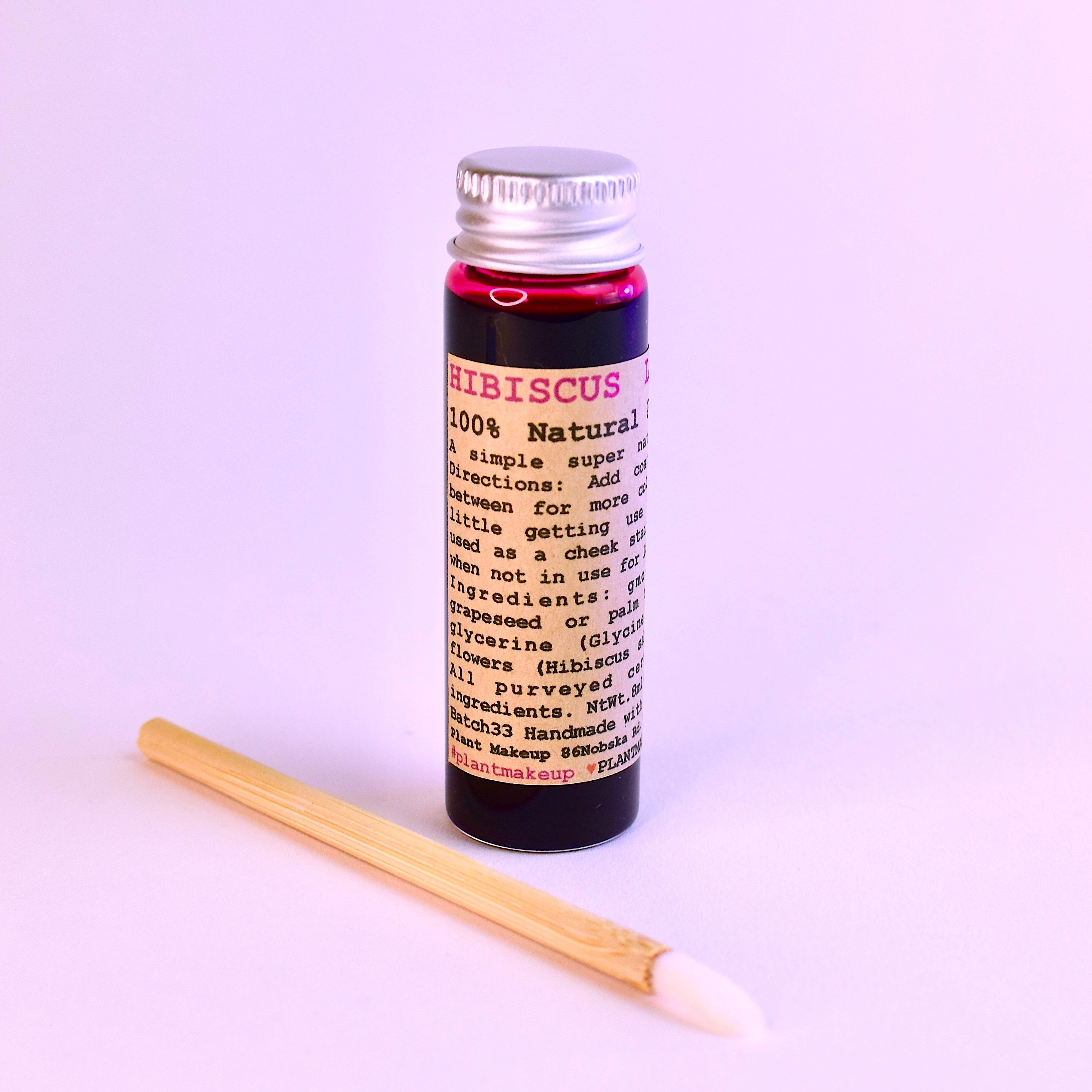 Mini and original size glass vials of Hibiscus Lip Stain by Plant Makeup