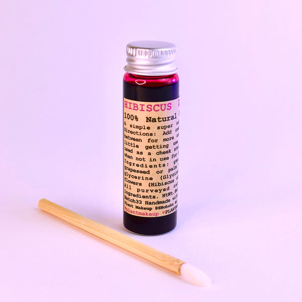 Mini and original size glass vials of Hibiscus Lip Stain by Plant Makeup