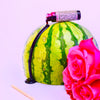 Glass vial of Hibiscus Lip Stain plant-based lip tint with bamboo wand