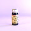 Bottle of Ibiscus Lime makeup on a light purple background