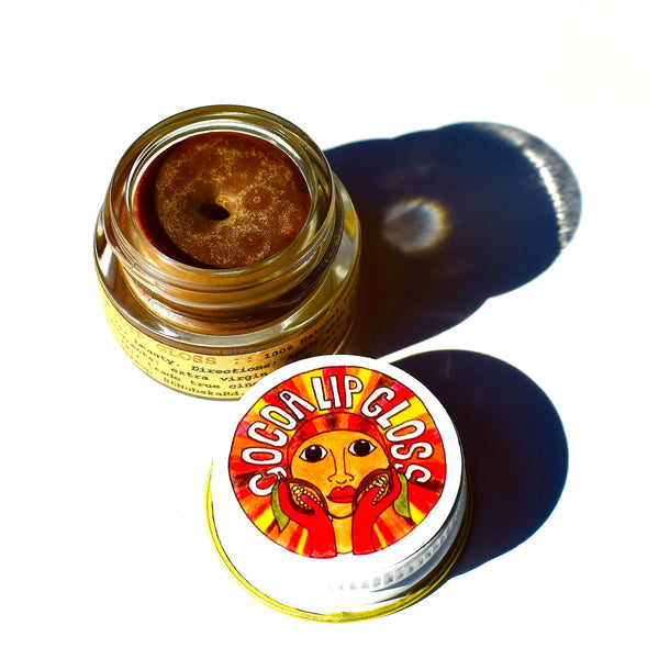 Plant Makeup Cocoa Lip Gloss in a glass jar with metal cap, made with organic cocoa butter and olive oil